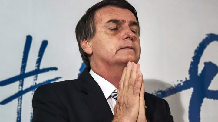 Brazilian deputy Jair Bolsonaro gestures during a press conference he called to announce his intention to run for the Brazilian presidency in the October 2018 presidential election, at a hotel in Rio de Janeiro on August 10, 2017.<br /> A controversial politician and former army paratrooper, Bolsonaro called himself the "patriot" Brazil needs, adding he is the answer to Brazil's rampant corruption, crime and economic malaise. He won more votes than any other congressman from Rio de Janeiro state in the last general elections in 2014 and polls currently show him tied in second place for the presidency, behind leftist former two term president Luiz Inacio Lula da Silva. / AFP PHOTO / Apu Gomes (Photo credit should read APU GOMES/AFP/Getty Images)